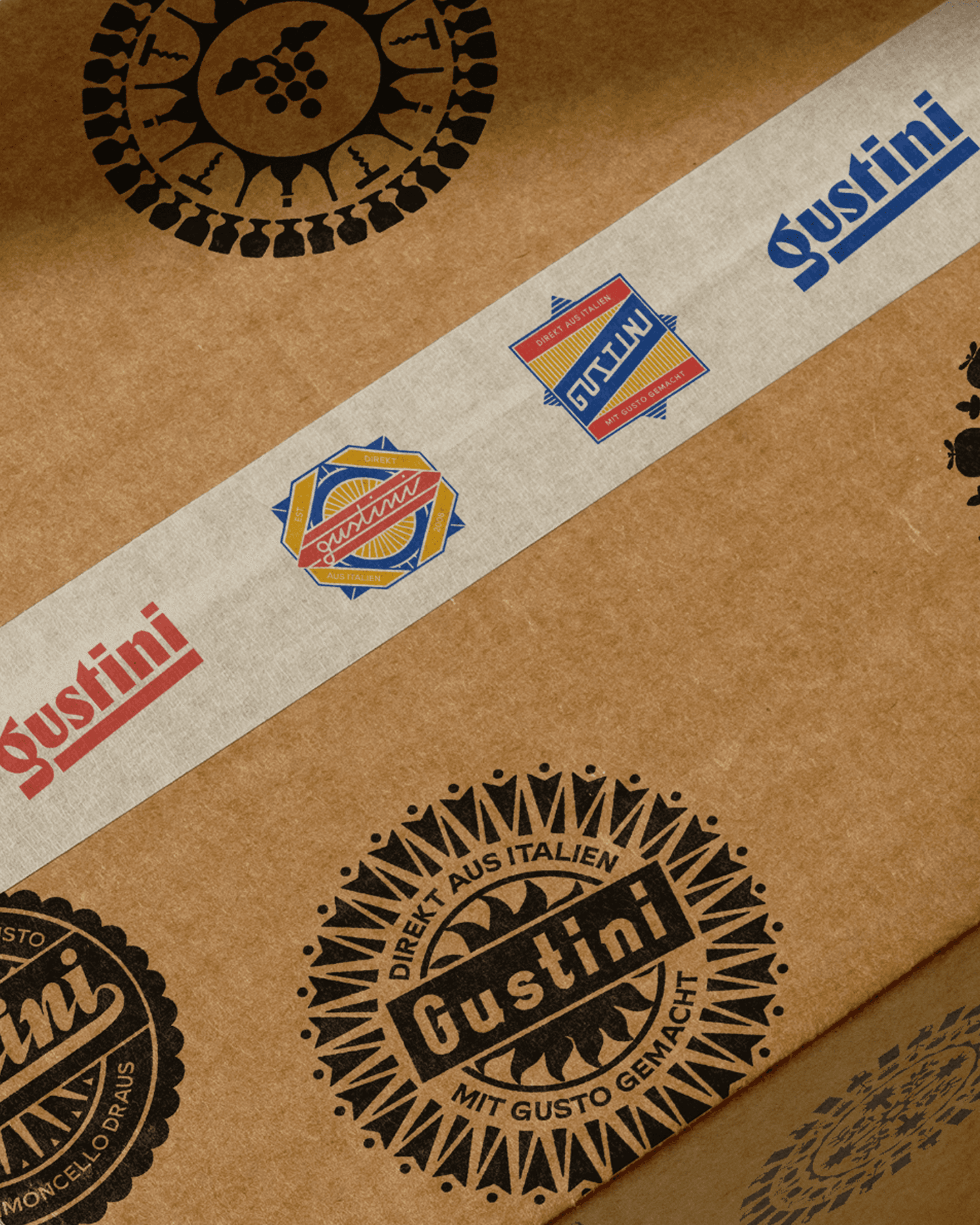 A cardboard box decorated with varying Gustini logo.