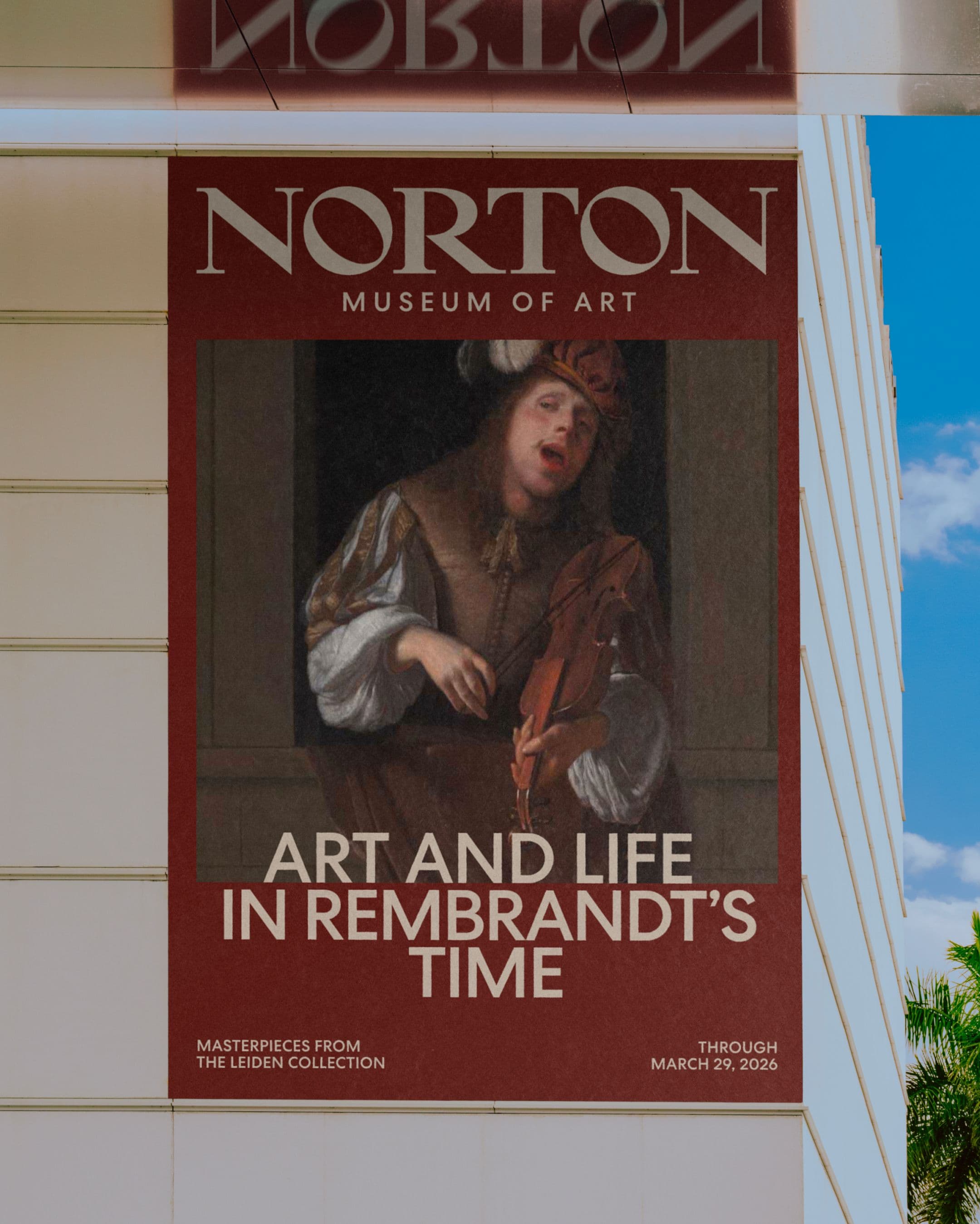 A large outdoor banner on the Norton Museum of Art building advertising the exhibition "Art and Life in Rembrandt's Time," featuring a Dutch Golden Age painting of a musician playing a stringed instrument. The banner notes the show includes masterpieces from the Leiden Collection, on view through March 29, 2026.